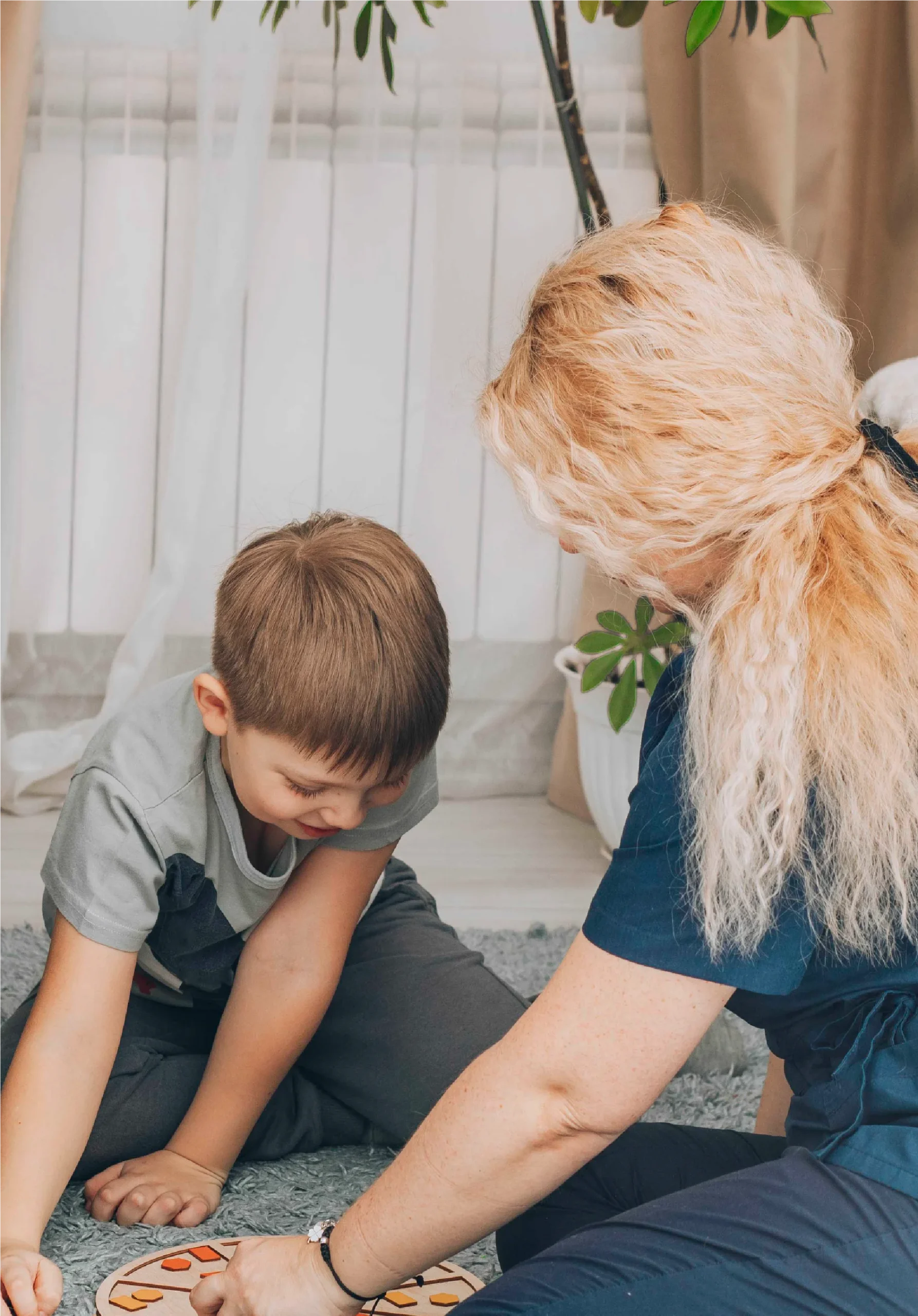 Young boy working with a specialist in ABA therapy